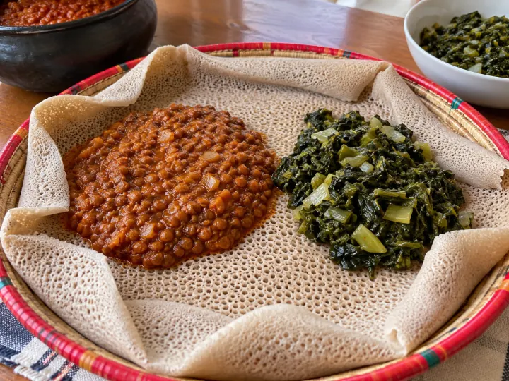Injera served with lentils and greens